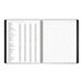 A black At-A-Glance spiral bound monthly planner with white pages.