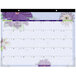 An At-A-Glance desk pad calendar for 2024 with purple paper flowers on it.