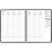 A black spiral bound At-A-Glance calendar with numbers and days of the week on it.