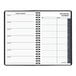 A spiral bound black At-A-Glance daily planner with white pages.