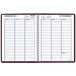 A spiral bound burgundy planner with a white background and black lines for dates and calendars.