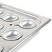 A Vollrath stainless steel pan with six small cups in it.