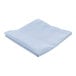 A folded light blue hemmed cloth table cover on a white surface.