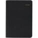 An At-A-Glance black daily appointment book with gold lettering on the cover.