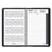 A black spiral-bound At-A-Glance daily appointment book with a calendar on it.
