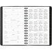 A spiral bound At-A-Glance 2025 weekly/monthly planner open to a white page with black circles for dates.