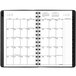 A spiral bound At-A-Glance planner with white pages and a graphite cover with numbers.