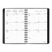 A graphite At-A-Glance planner with a calendar on it.