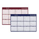 An At-A-Glance reversible wall planner with blue and red backgrounds, numbers, and days.