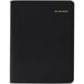 An At-A-Glance black appointment book with gold lettering.