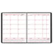 An At-A-Glance black spiral-bound monthly business planner page with red lines.
