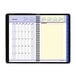A spiral bound black and white At-A-Glance calendar with numbers and days of the month.