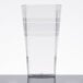 A clear plastic tumbler with a stripe on it.