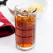 A glass of Anchor Hocking iced tea with a lemon wedge.