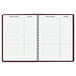 An At-A-Glance spiral bound weekly appointment book with lines on the pages.