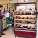 A man looking at food in an Alto-Shaam hot food display case.