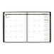 A black At-A-Glance weekly/monthly appointment book with spiral bound pages and green and white calendar pages.