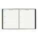 A black At-A-Glance monthly planner with lined pages and a spiral binding.