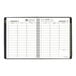 A black At-A-Glance planner with green accents and spiral binding.
