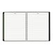 A spiral bound At-A-Glance appointment book with lined pages and a black cover.