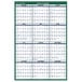 An At-A-Glance vertical wall planner with a white background, green border, and white dates and months.