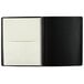 A black At-A-Glance planner with white pages and a black spiral binding.