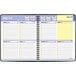 A spiral bound At-A-Glance planner with a black cover featuring a calendar and days of the week.