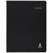 A black notebook with a pink ribbon on the cover.