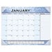 An At-A-Glance desk pad calendar with white paper and black lines, blue and white with numbers and notes.