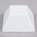 A white square Elite Global Solutions melamine bowl.