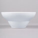 A close-up of an Elite Global Solutions white melamine bowl.