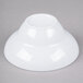 A white Elite Global Solutions melamine bowl on a gray surface.