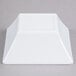 A white square Elite Global Solutions melamine bowl.