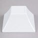 A white square Elite Global Solutions melamine bowl.