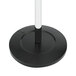 A black coat stand with white knobs on top of a white base.