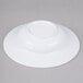 a white bowl on a gray surface