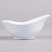 A white oblong melamine sauce dish with a curved edge.