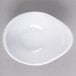 A white oblong melamine sauce dish with a spiral design.