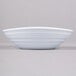 An Elite Global Solutions white melamine bowl on a gray surface.