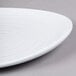 A white plate with a swirl pattern on it.