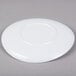 a white plate on a gray surface