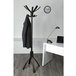 An Alba espresso brown wood coat stand with coats hanging on it.