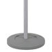 A grey pole on a white base with a wavy top.