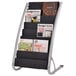 A black and silver Alba magazine rack holding magazines.