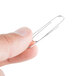 A person holding a silver Acco paper clip.