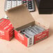 A close-up of a red Acco box of paper clips.