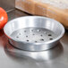 An American Metalcraft heavy weight aluminum pizza pan with perforations.