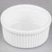 A Tuxton porcelain white fluted ramekin with a rim.