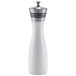 A white and wood pepper mill with an aluminum accent.