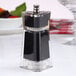A black and silver Chef Specialties Kate salt or pepper mill on a table.